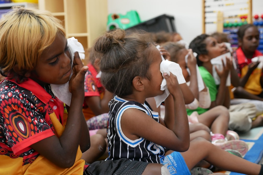 Students at Yipirinya School wiping their eyes.