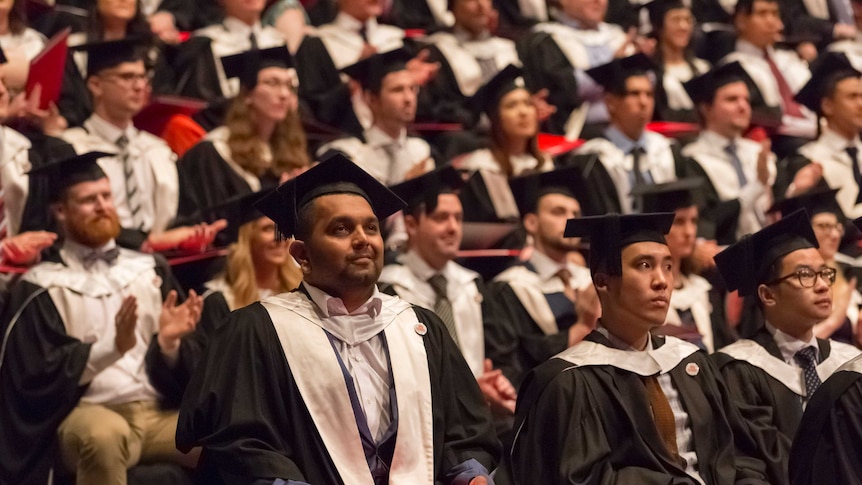 Dinesh Palipana sitting in his wheelchair at his graduation ceremony