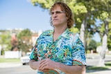 Colour still of Joaquin Phoenix wearing hawaiian shirt and sunglasses in 2018 film Don't Worry, He Won't Get Far on Foot.
