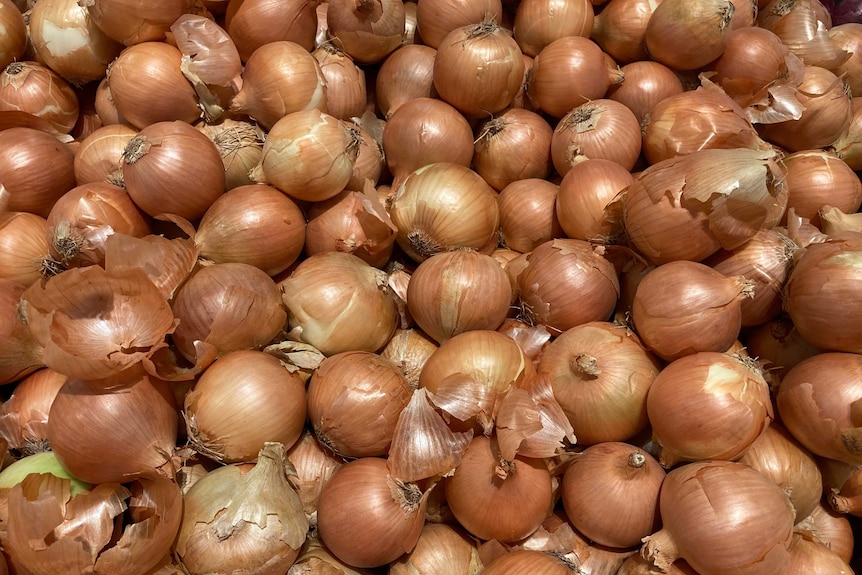 a pile of onions in a supermarket