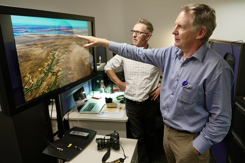 Gary and Mike look at an image of a river system.