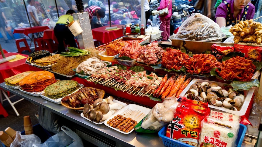An array of Korean foods at a market stall.