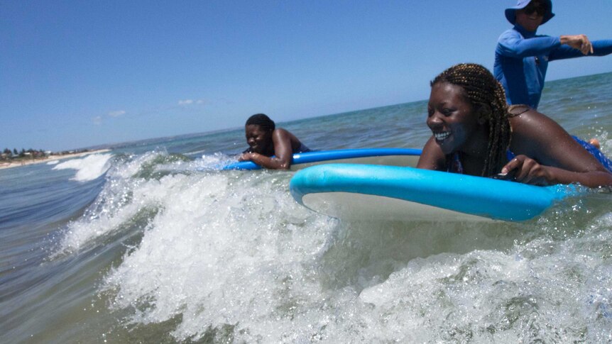 Imabong and Imebong Idim catch a wave on Henley Beach.