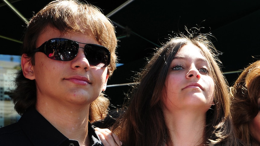 Prince Jackson (L), Paris Jackson (R) and Blanket Jackson (front) attend a ceremony to honour their father