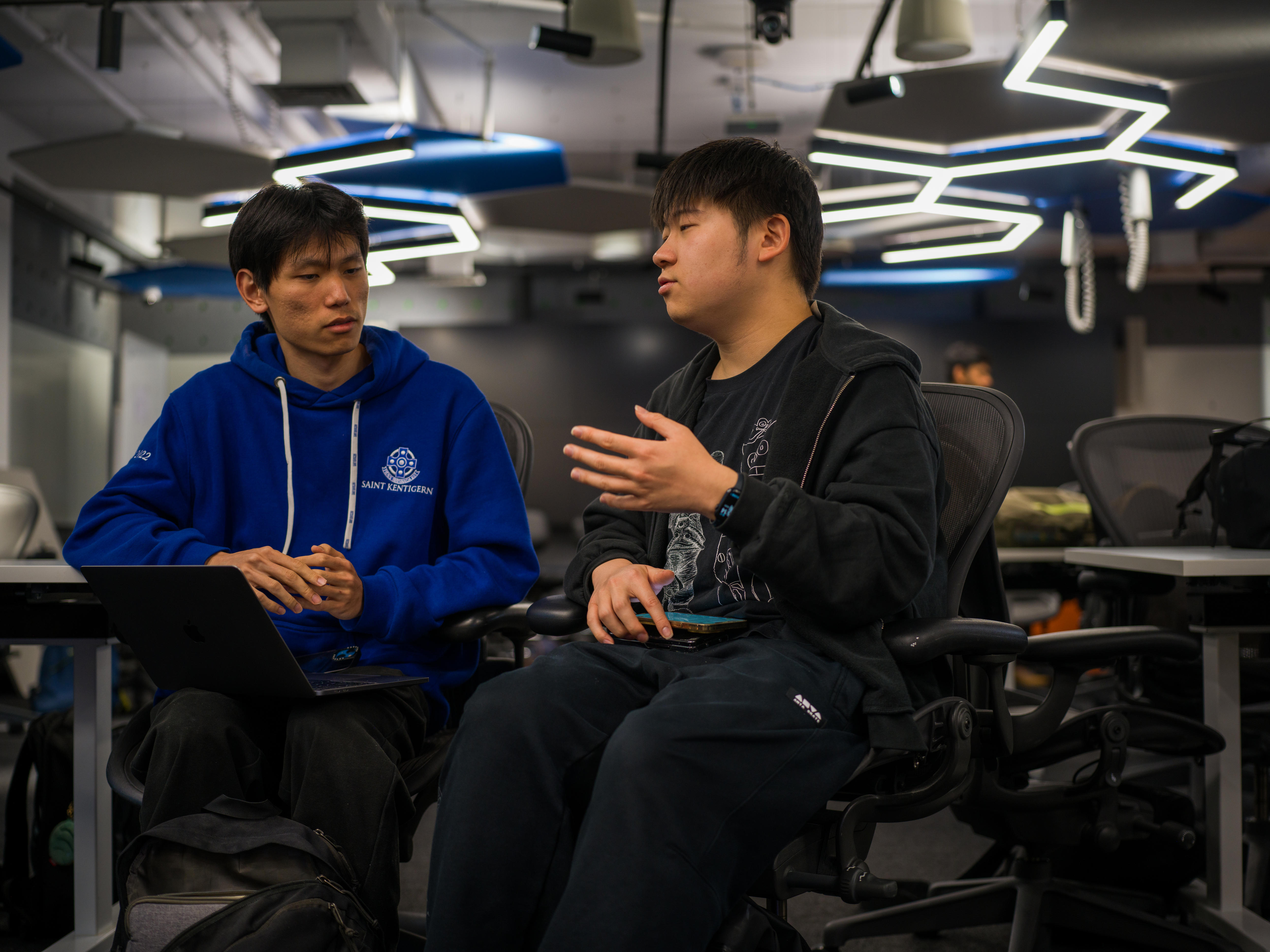 Two students discussing strategy during the competition.