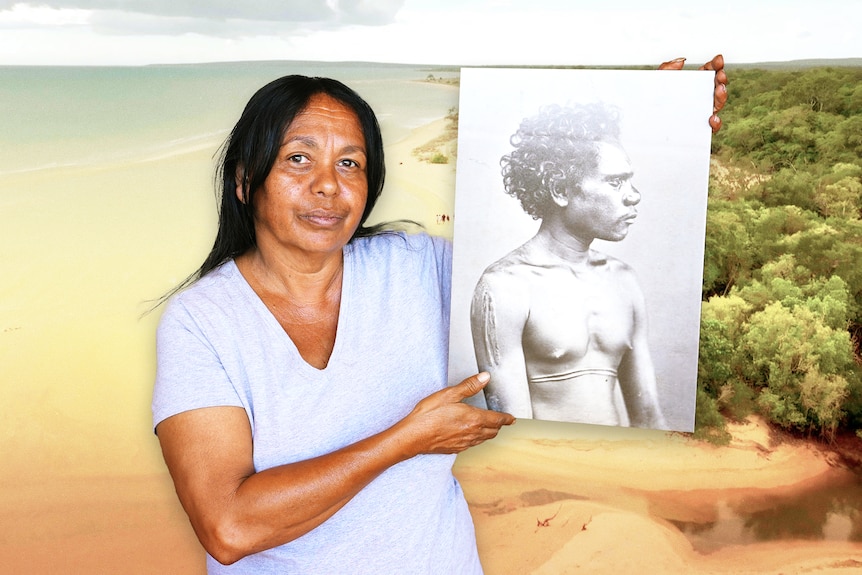 A woman holding a photograph f a traditional Indigenous man