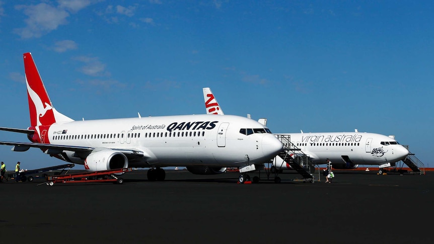 Qantas planes beside Virgin plane