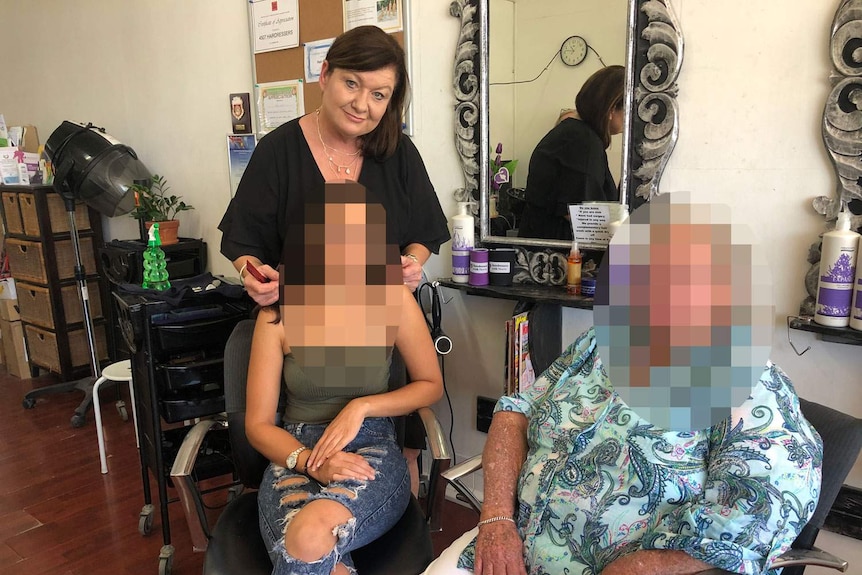 Ms Colvin with two clients she has helped - faces pixelated.