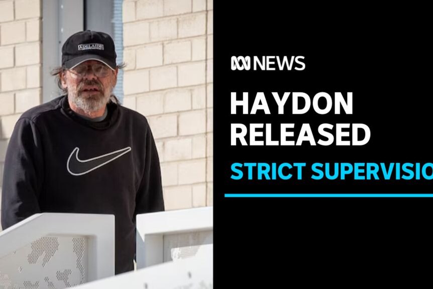 Haydon Released, Strict Supervision: A man with a scruffy face, in a baseball hat and a Nike t-shirt looks at the camera