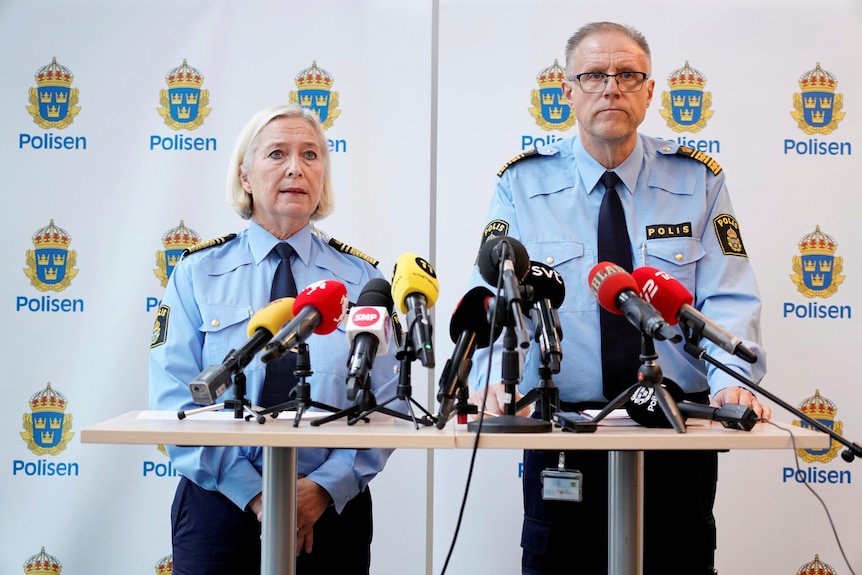 Police officers giving a press conference. 