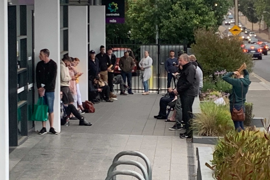 People waiting around outside a Centrelink office
