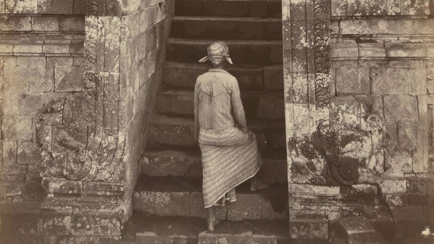 Man climbing the front entrance to Borobudur, Central Java 1872. Albumen silver photo.