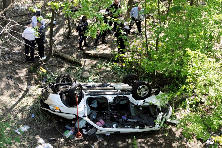 Accident investigators work at the scene of the crash.