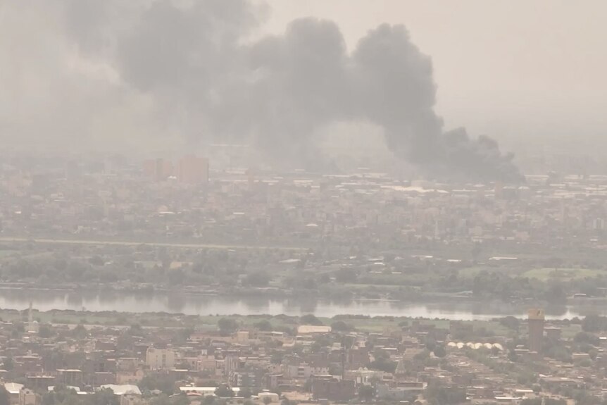 Plumes of smoke rise from a Sudanese city.