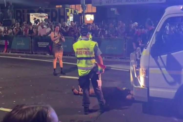 A woman on ground police around her