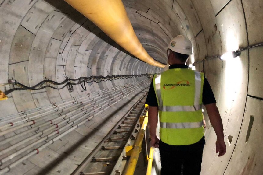 An Ampcontrol worker walks through a train tunnel that is under construction in Singapore.