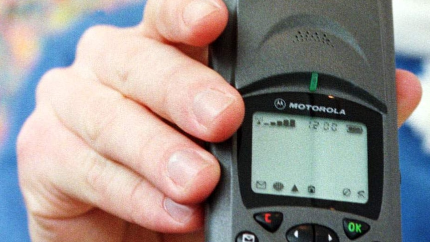 A man holds the Motorola Iridium satellite telephone.