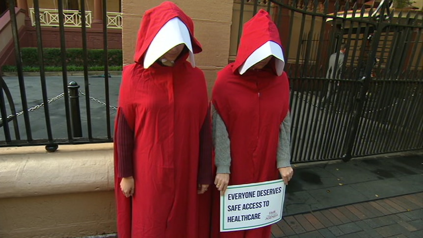 Two woman dressed in red clothing