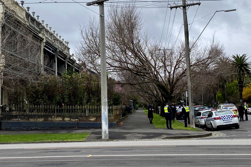 Police cars and officers are seen on a Melbourne street