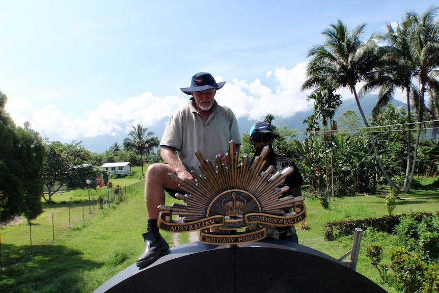 Len Thompson and a local volunteer working on the Kokoda Memorial Archway.