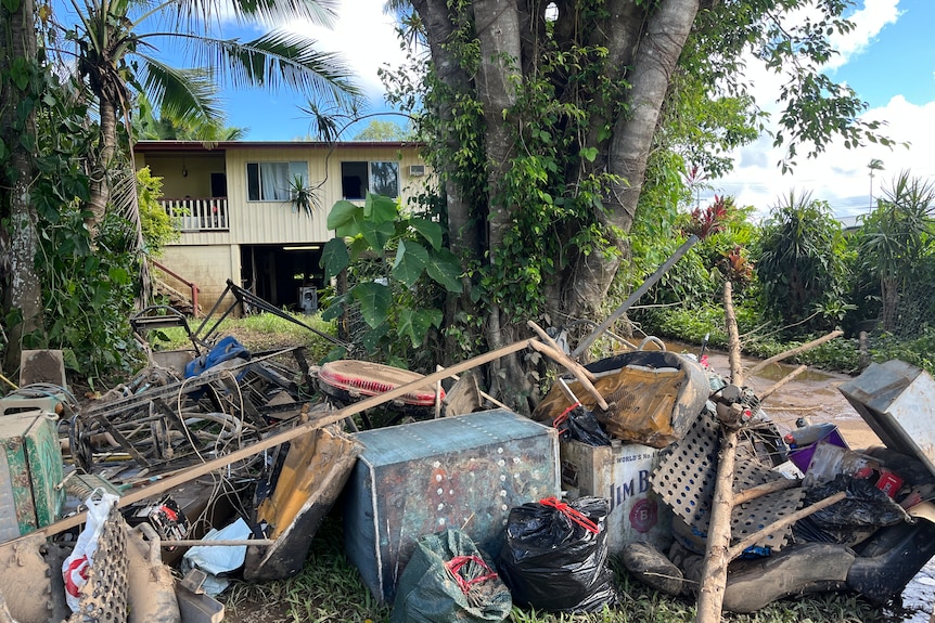 A pile of junk in front of a house