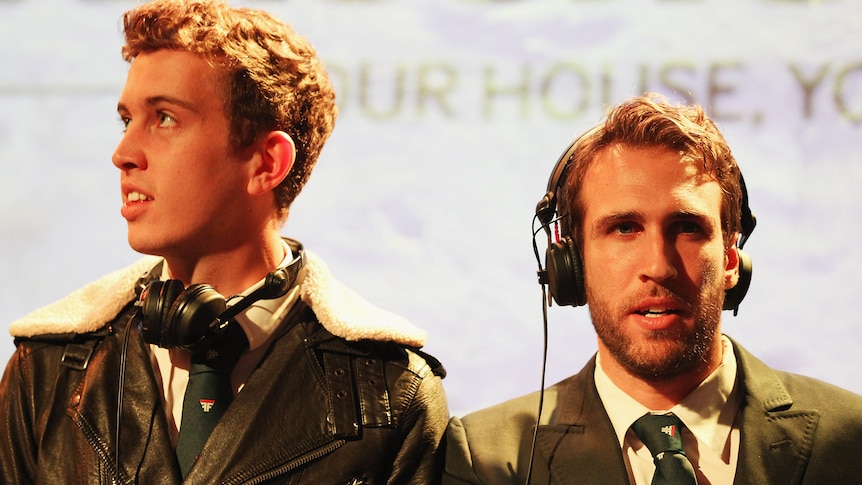 two men wearing pilot outfits and headphones
