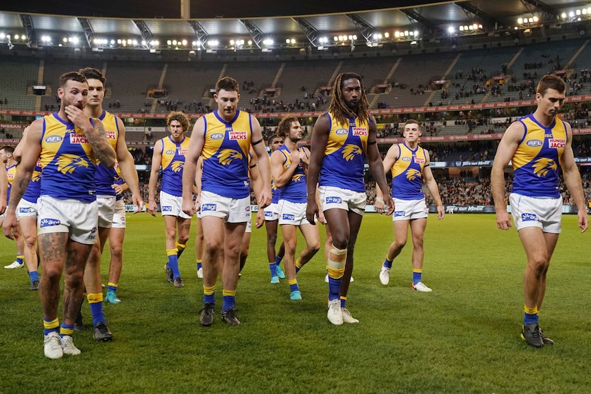 West Coast players leave the field looking dejected after their lose to the Cats.
