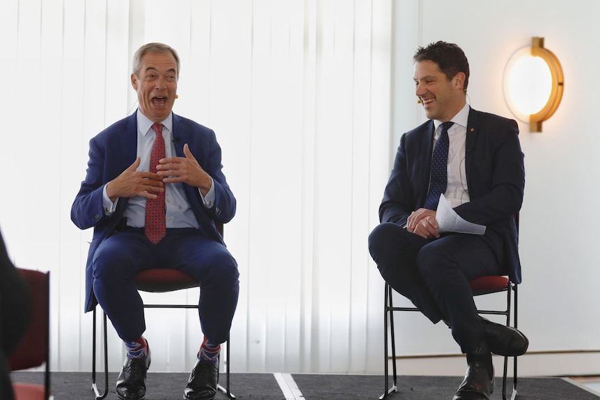 Alex Antic laughs as Nigel Farage speaks at Parliament House
