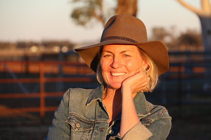 Close up photo of woman outside in a rural setting.