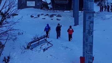 Skier falls as chairlift dislodges off cable.