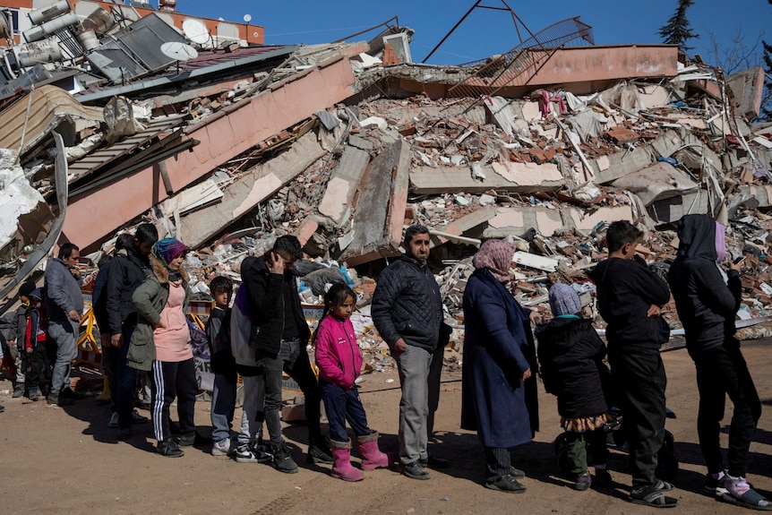  People queue for free food served, amid the rubble following the deadly earthquake in Kahramanmaras.