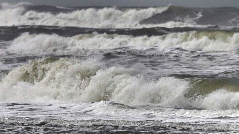 Surf pounds a beach