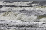 Surf pounds a beach