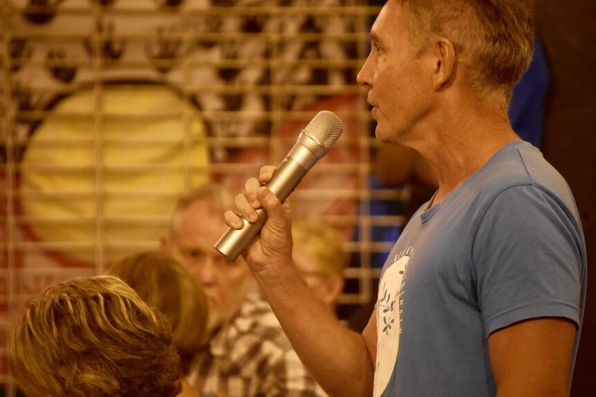 A man speaks into a microphone.