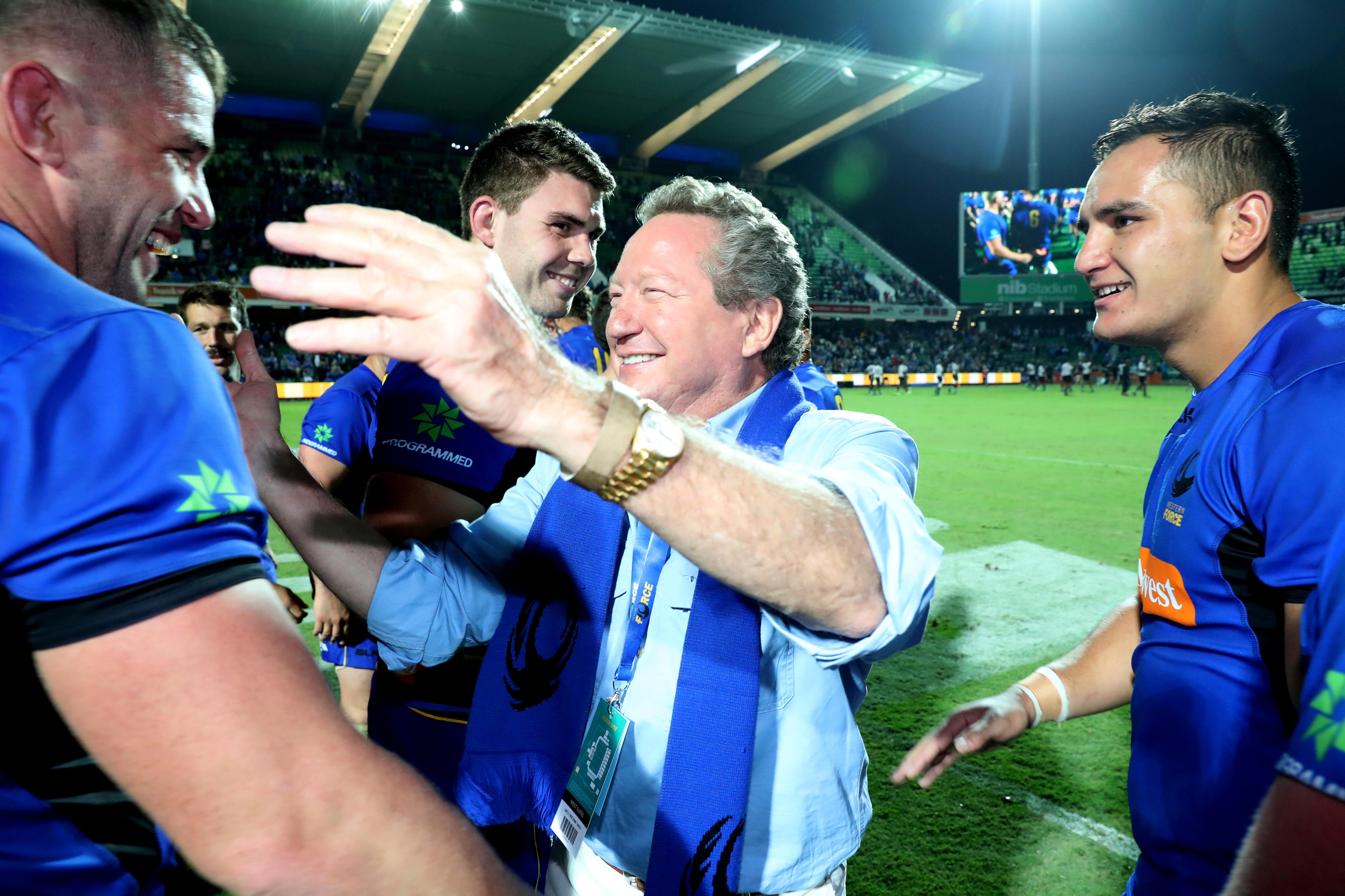 A man hugging a rugby player after a match