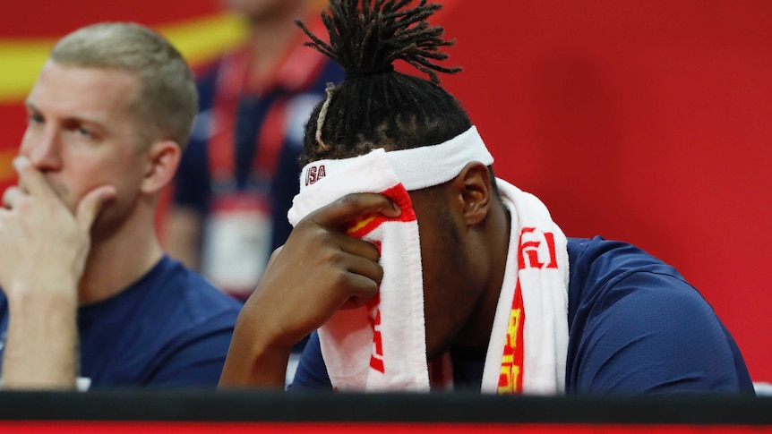 Myles Turner holds a towel to his face