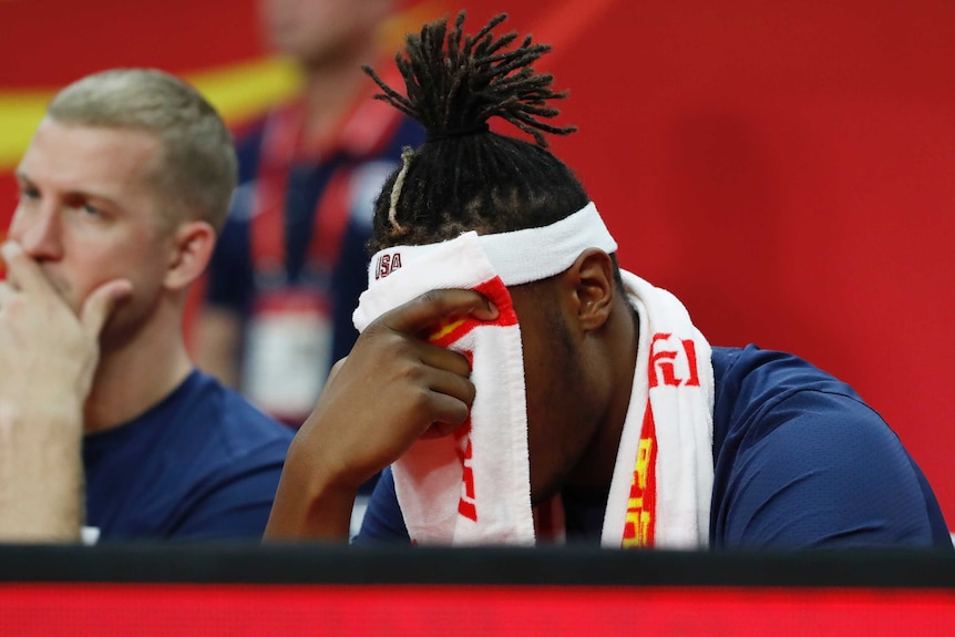 Myles Turner holds a towel to his face