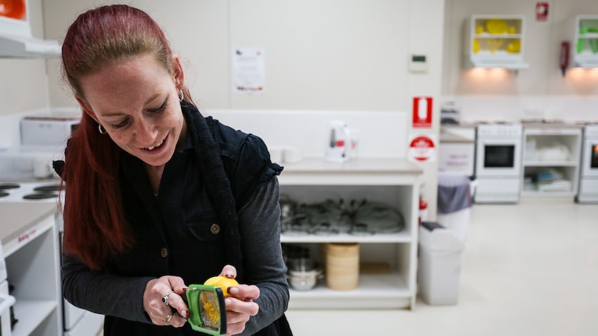 Hope is grating lemon zest in preparation for the baked lemon cake with syrup.