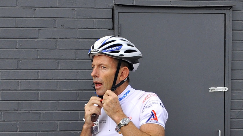 Tony Abbott puts on his helmet