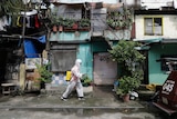 A man wearing a hazmat suit disinfects a slum neighbourhood in Calcoocan city, Philippines.
