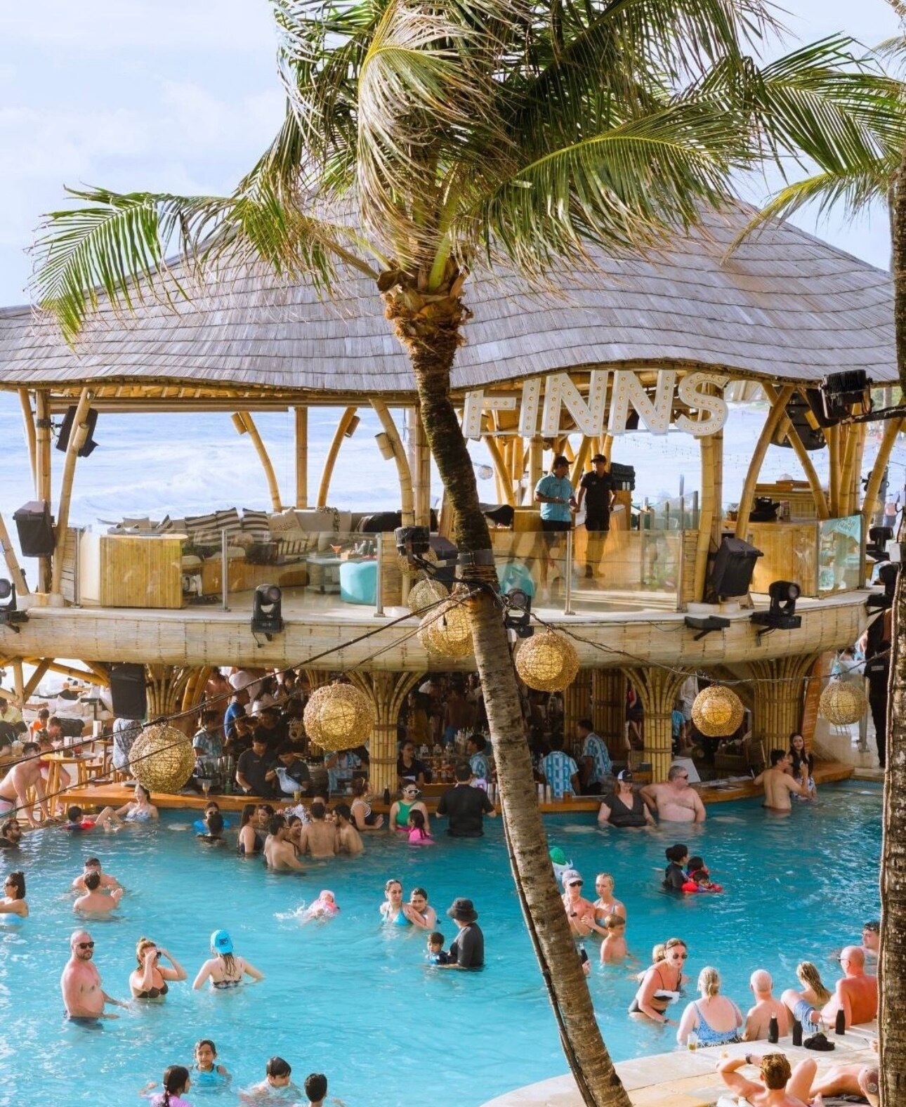 People dance at a popular beach club in Bali