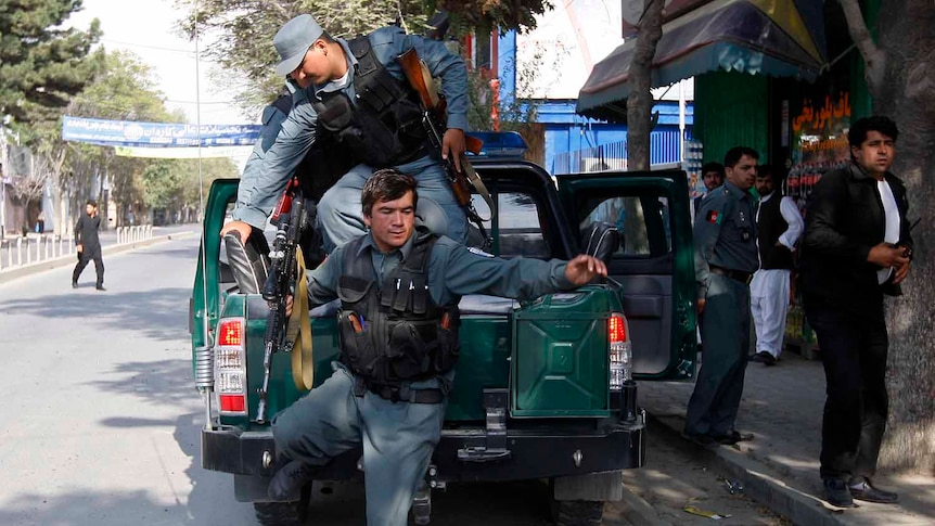 Afghan policemen arrive at the site of a rocket-propelled attack in Kabul.