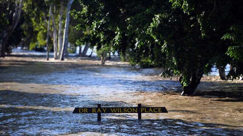 A sign is just above water level on the banks of the Fitzroy river in Rockhampton.