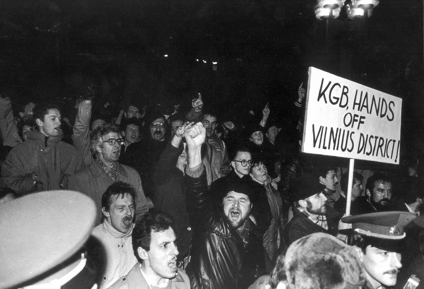 A black and white photo f a protesting crowd One sign reads 'KGB hands off Vilnius district'