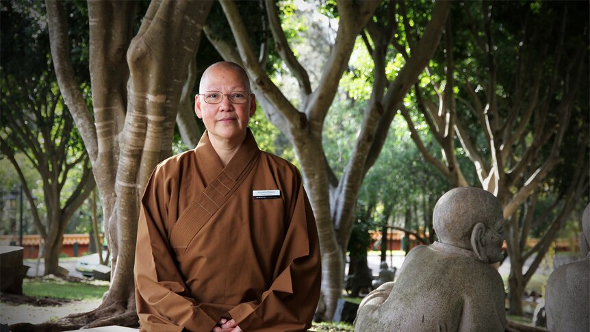 Reverend Maio You sits in the garden at the Nan Tien Temple at Wollongong