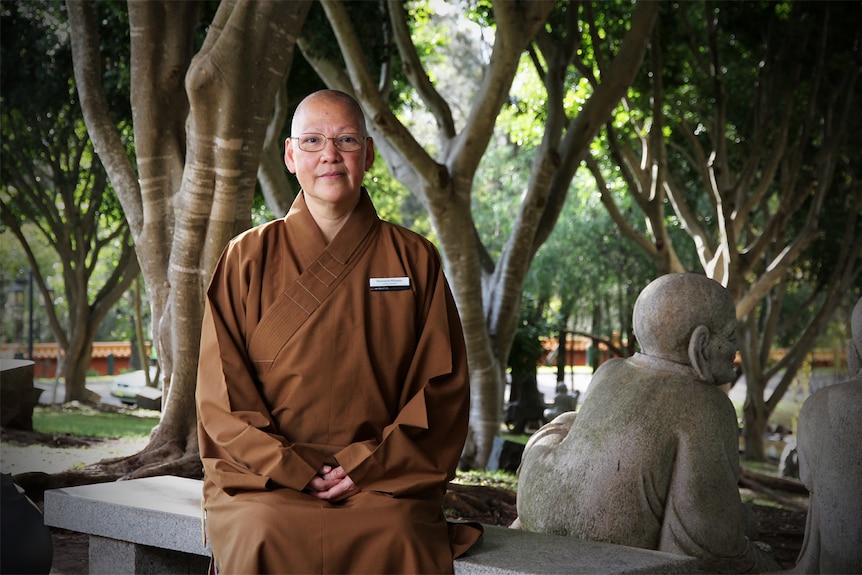 Reverend Maio You sits in the garden at the Nan Tien Temple at Wollongong