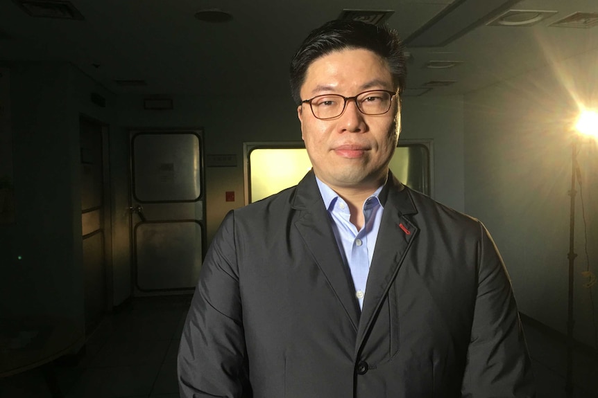 Dr Go Myong-Hyun stands in an empty room facing the camera.