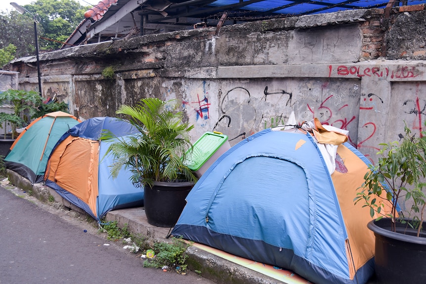 Tents line a dusty laneway in Jakarta.