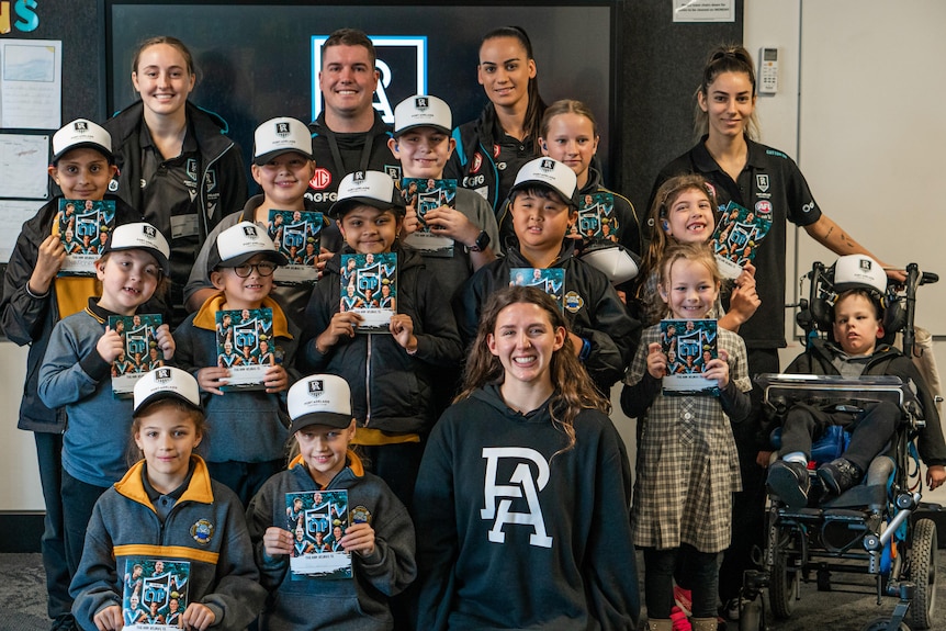 A group shot of all the students with three AFLW Port Adelaide players