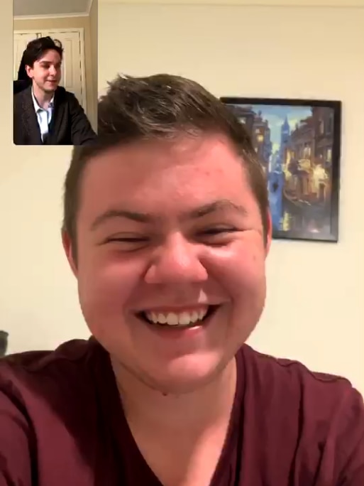 A screenshot of teenage boy laughing while using facetime
